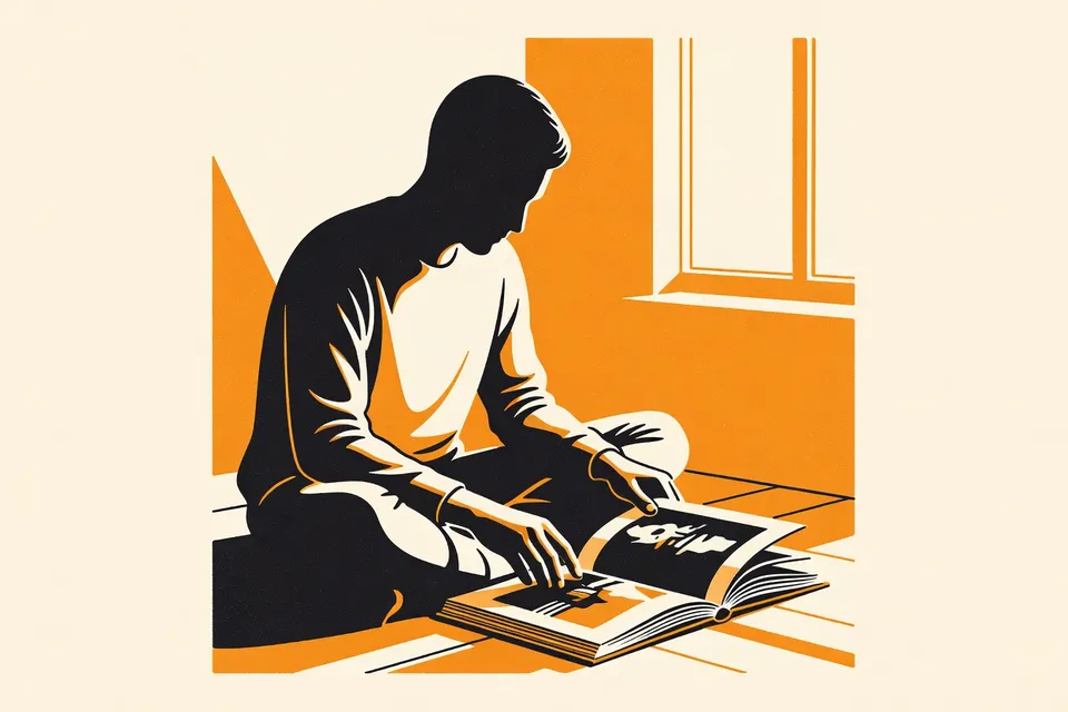 A person sitting on a wooden floor, holding an open photobook in soft morning light, with a hand pausing over a black-and-white photograph.